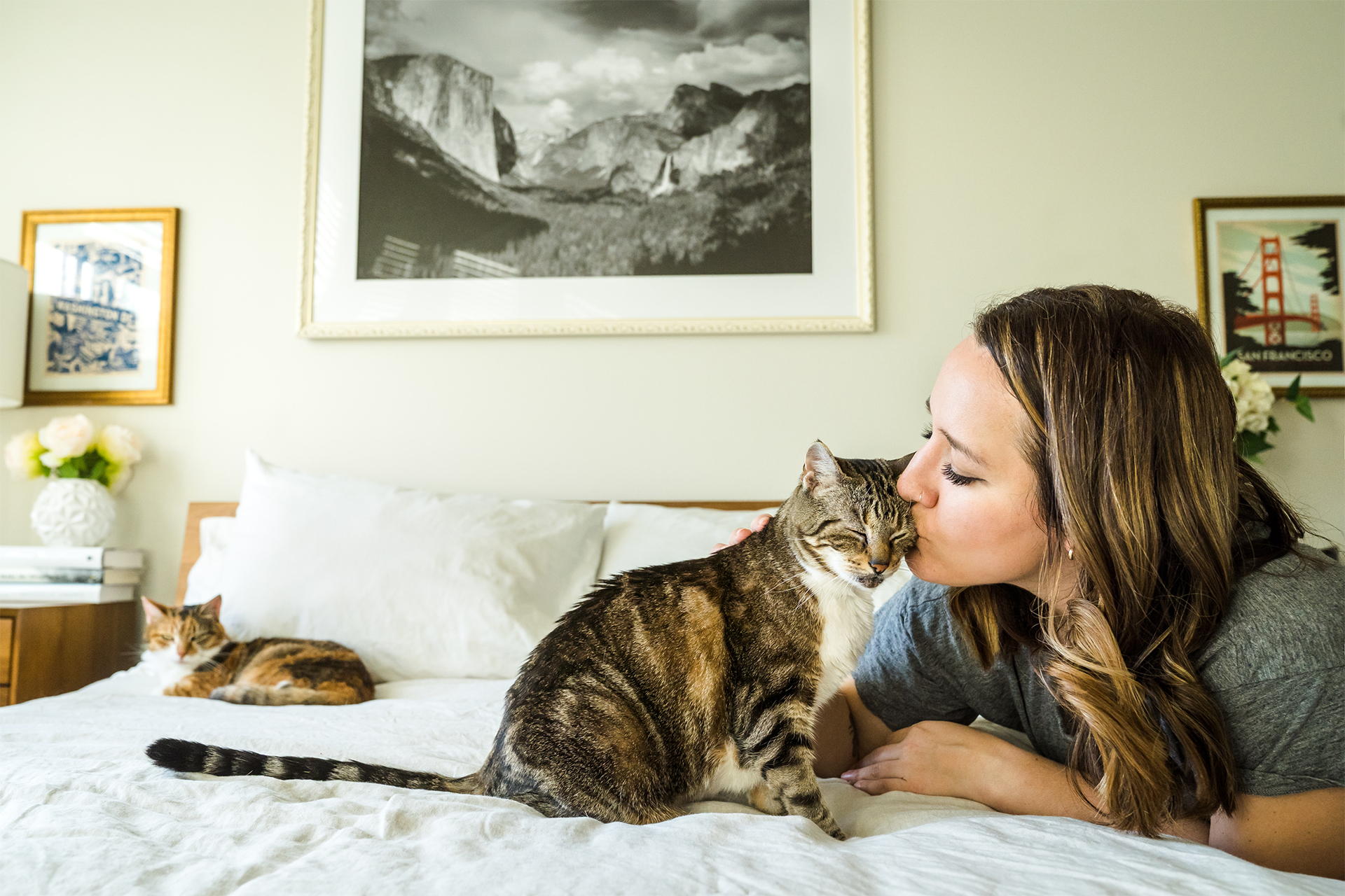 Girl kissing her cat on the bed in Bend, Oregon