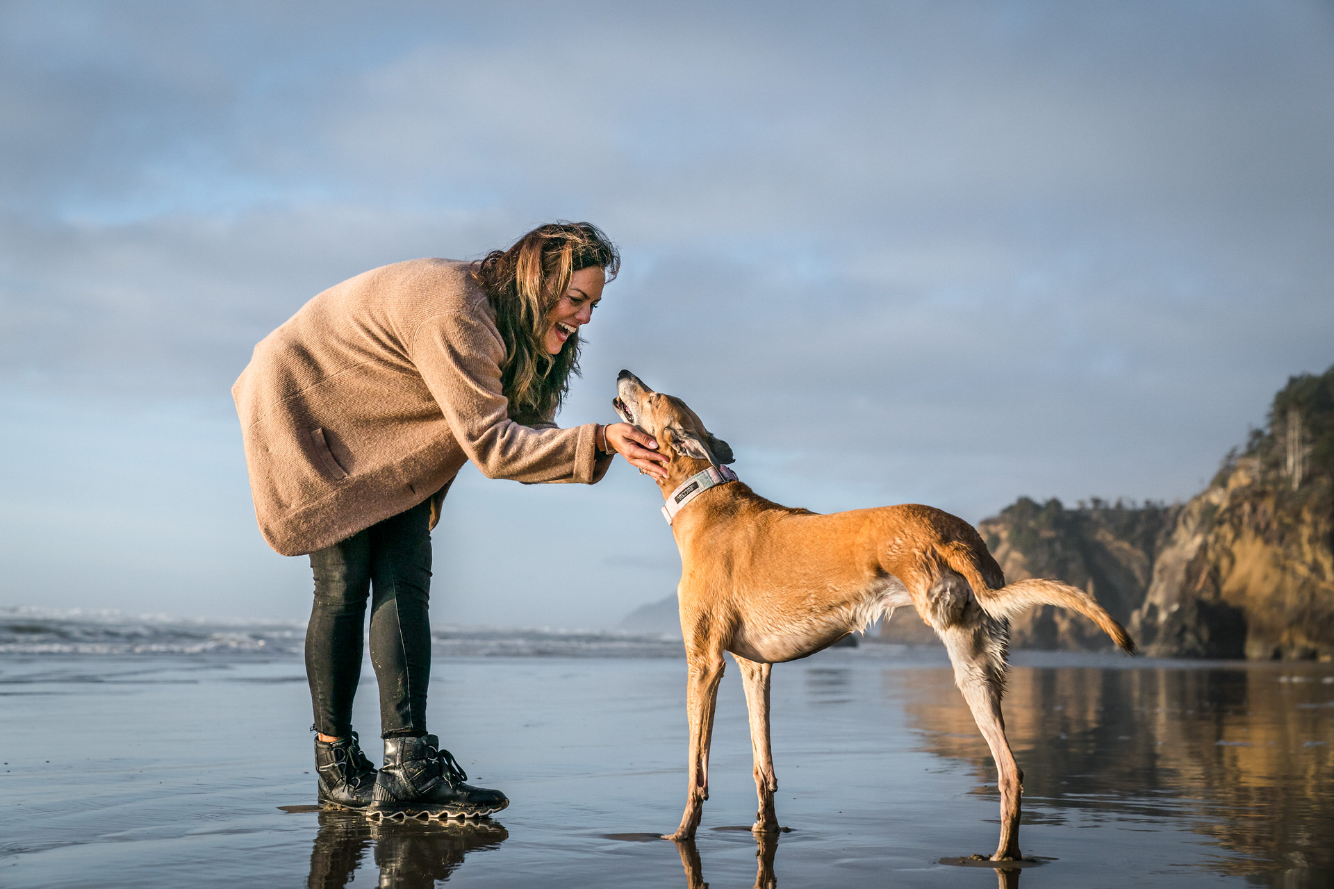 woman with dog on beach