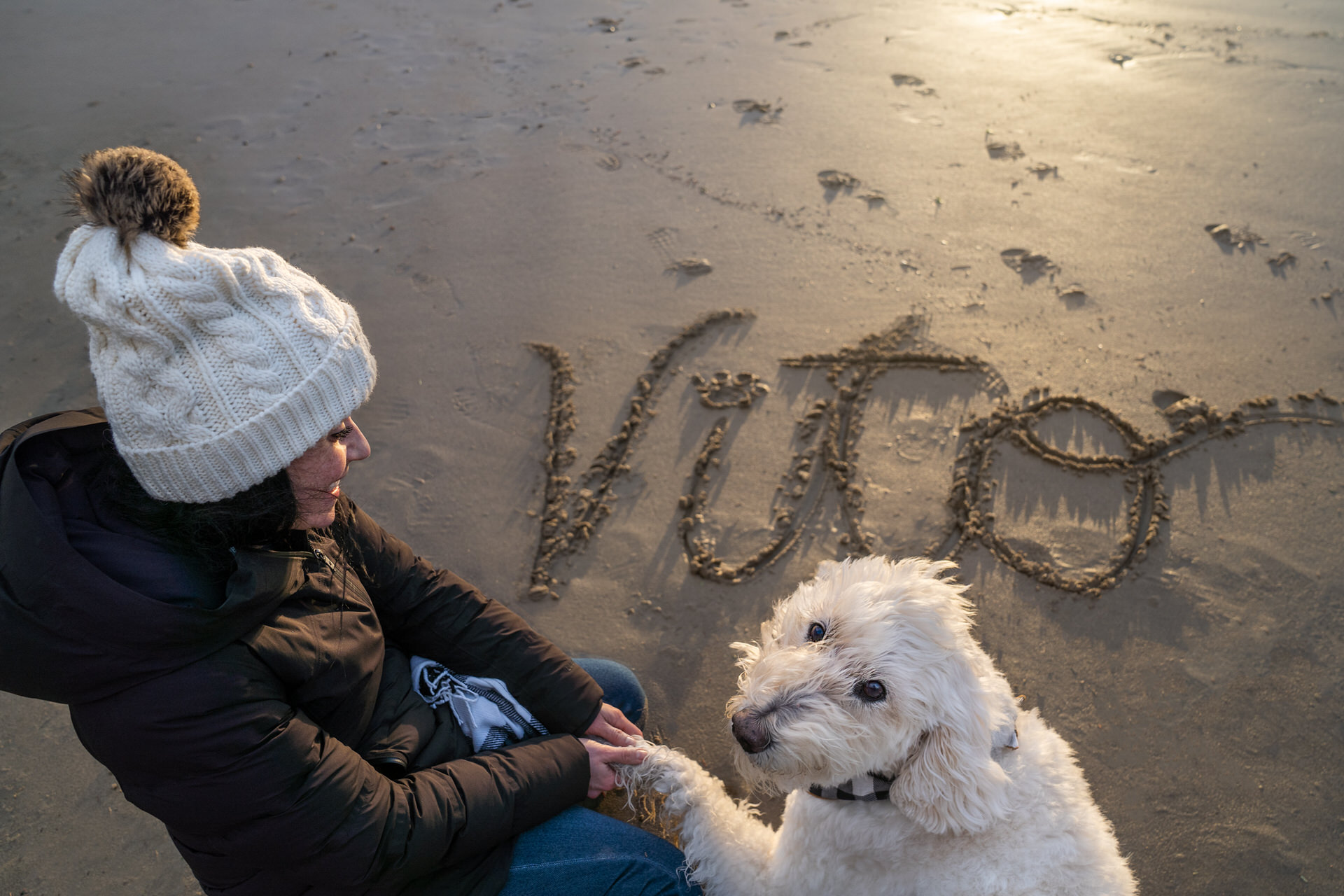 winter on the beach with her dog's name in the sand