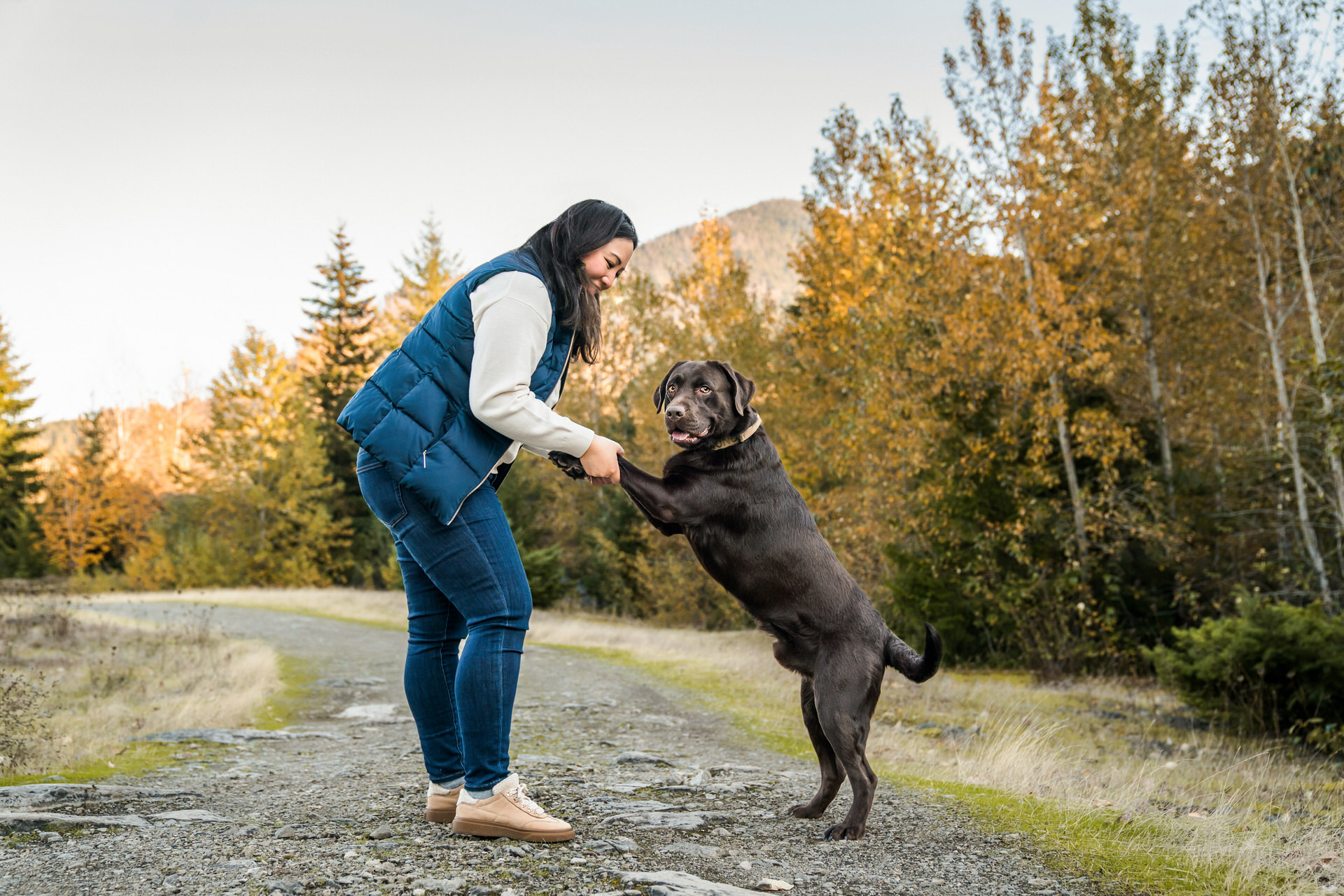 woman and dog play together during their photo shoot with lindsay baca